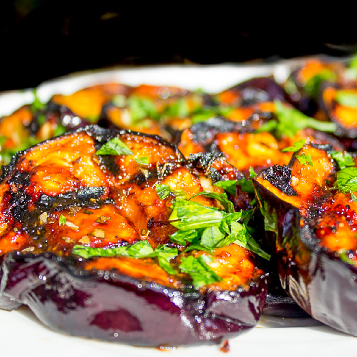 grilled sliced eggplant on cutting board.