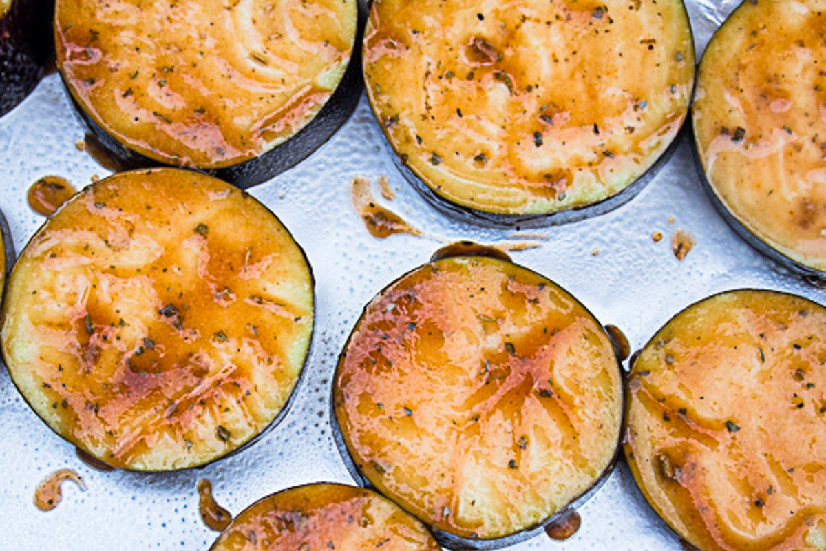 marinated eggplant slices on tray.