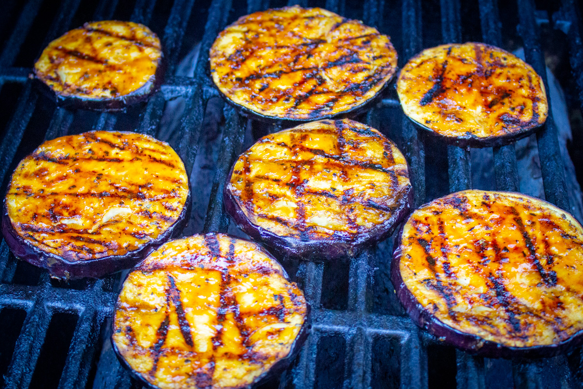 glazed sliced eggplant on grill.