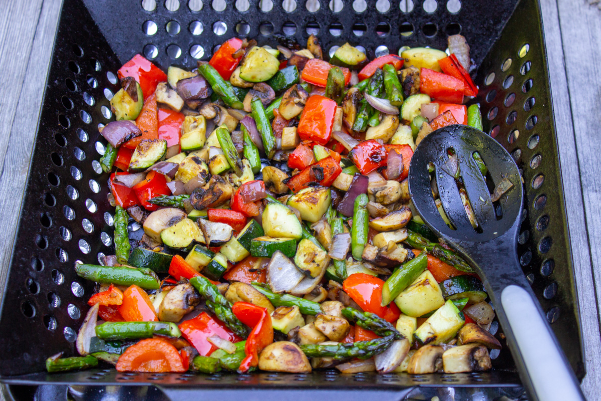 grilled diced veggies in grill basket.