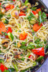 spaghetti with grilled veggies in wine sauce in skillet.