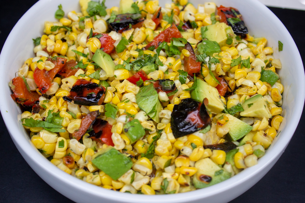 charred corn salad in a bowl garnished with cilantro.