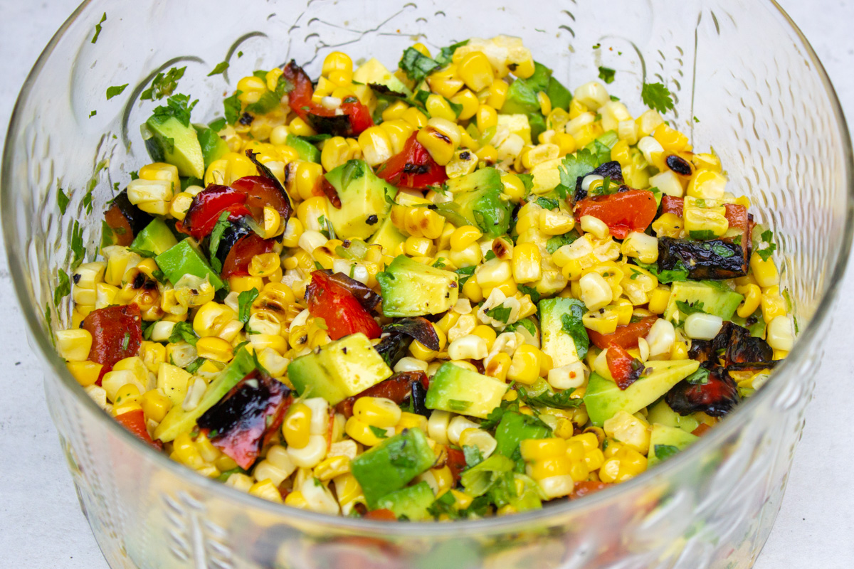 charred corn salad in a glass bowl garnished with cilantro.