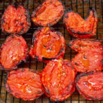 fire roasted tomatoes sitting on wire rack over baking sheet.