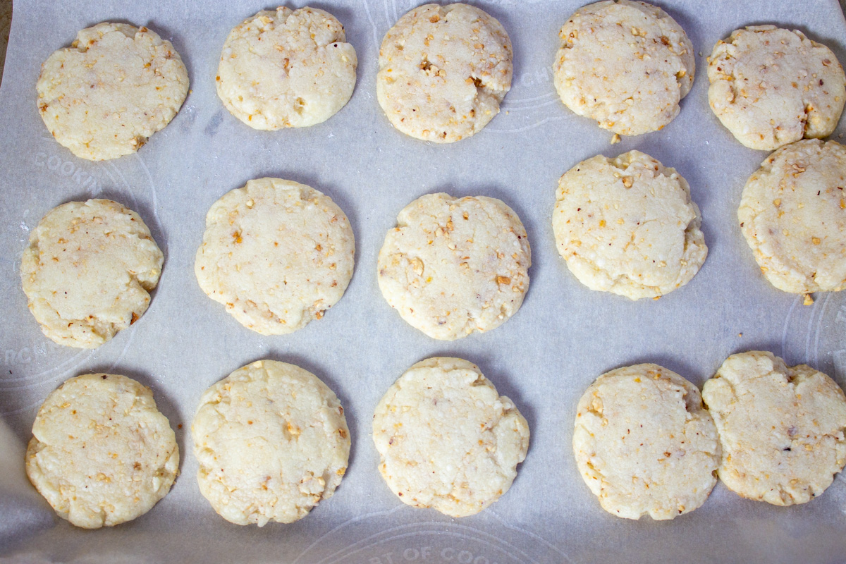 raw hazelnut cookies on parchment lined baking sheet.