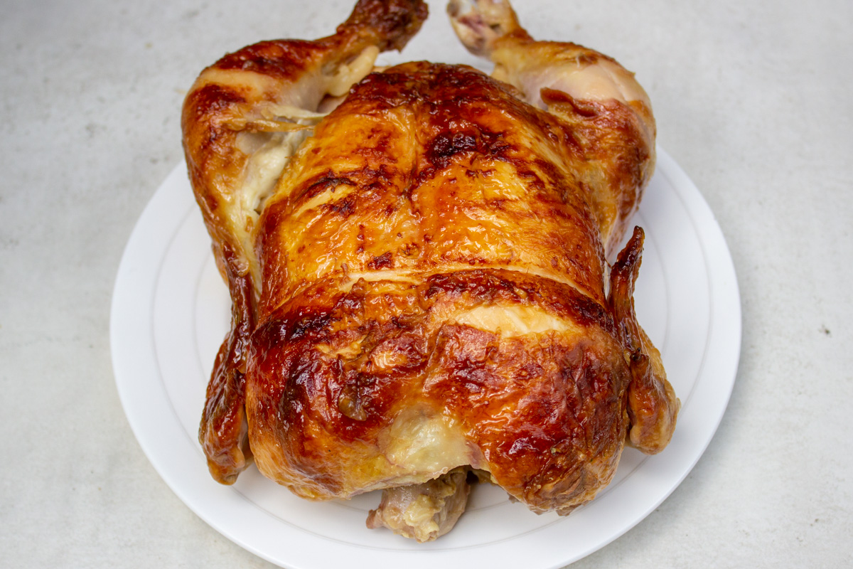 cooked rotisserie chicken on plate.
