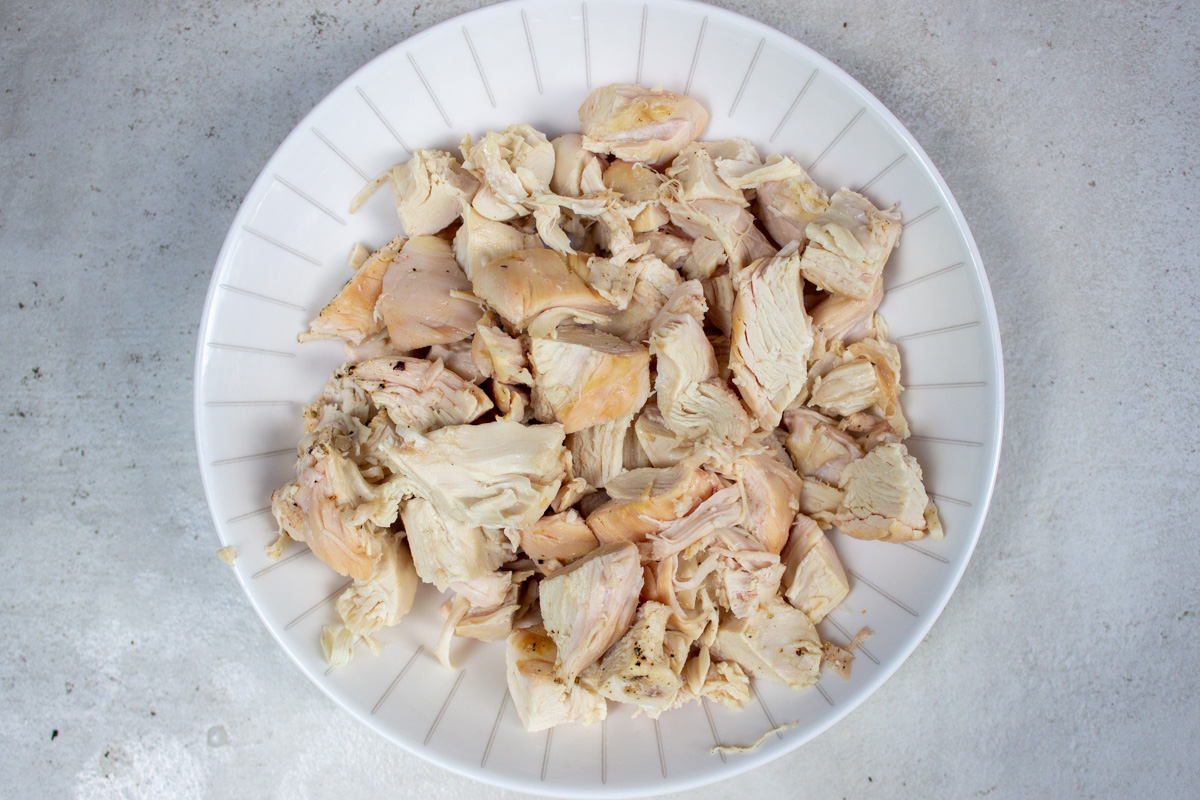 chopped rotisserie chicken in bowl.