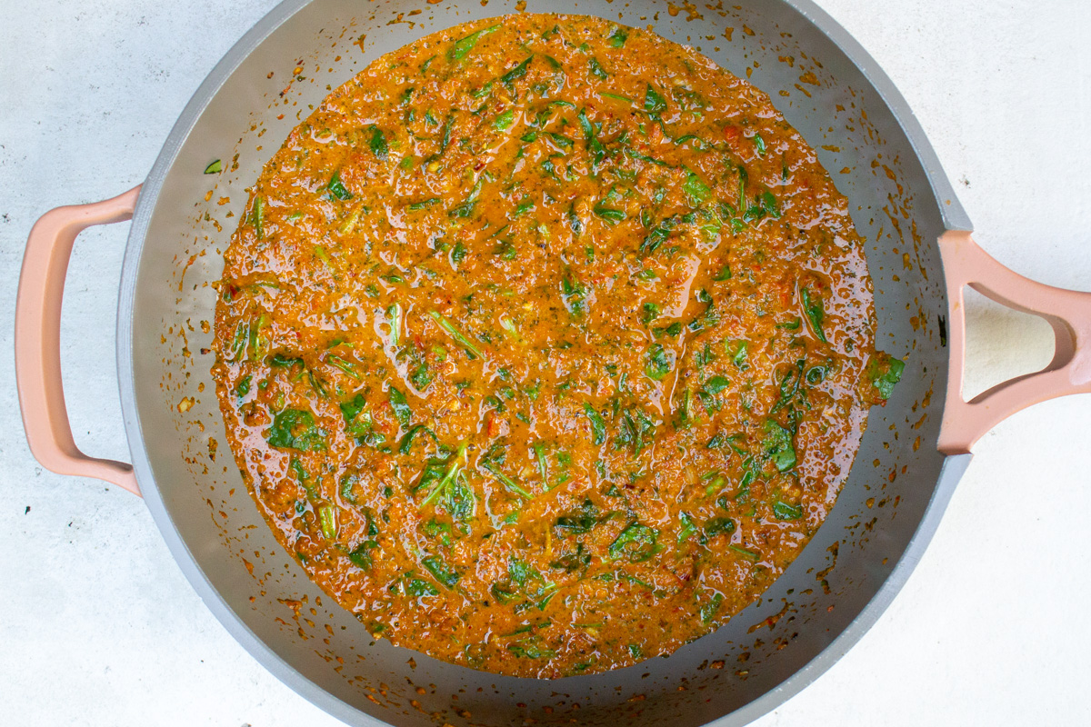 sauce and spinach in skillet.