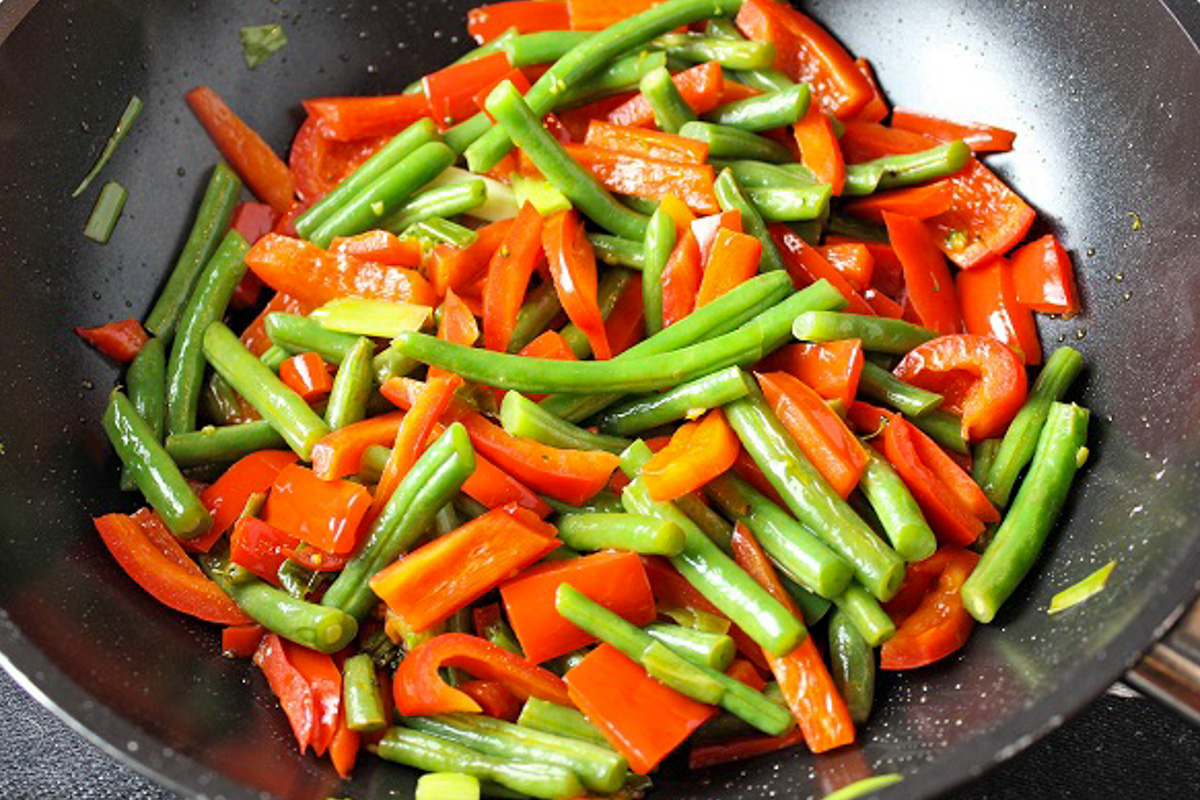 fresh veggies sauteeing in skillet.