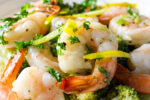baked shrimp with gremolata dressing in dish.