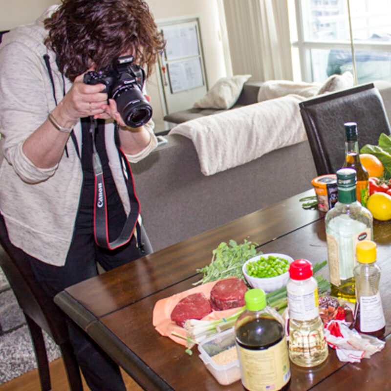 author Cheryl taking photograph of ingredients for a recipe.