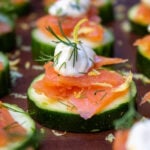 smoked salmon canapes on cucumber garnished with dill and lemon zest.