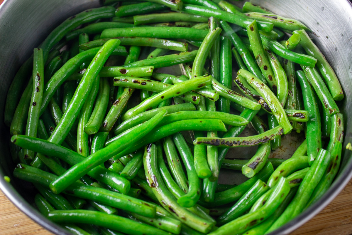 sauteed green beans charred in skillet.