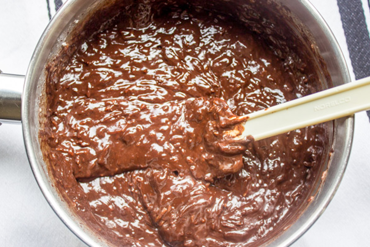 cream and coconut added to chocolate mixture in pot.