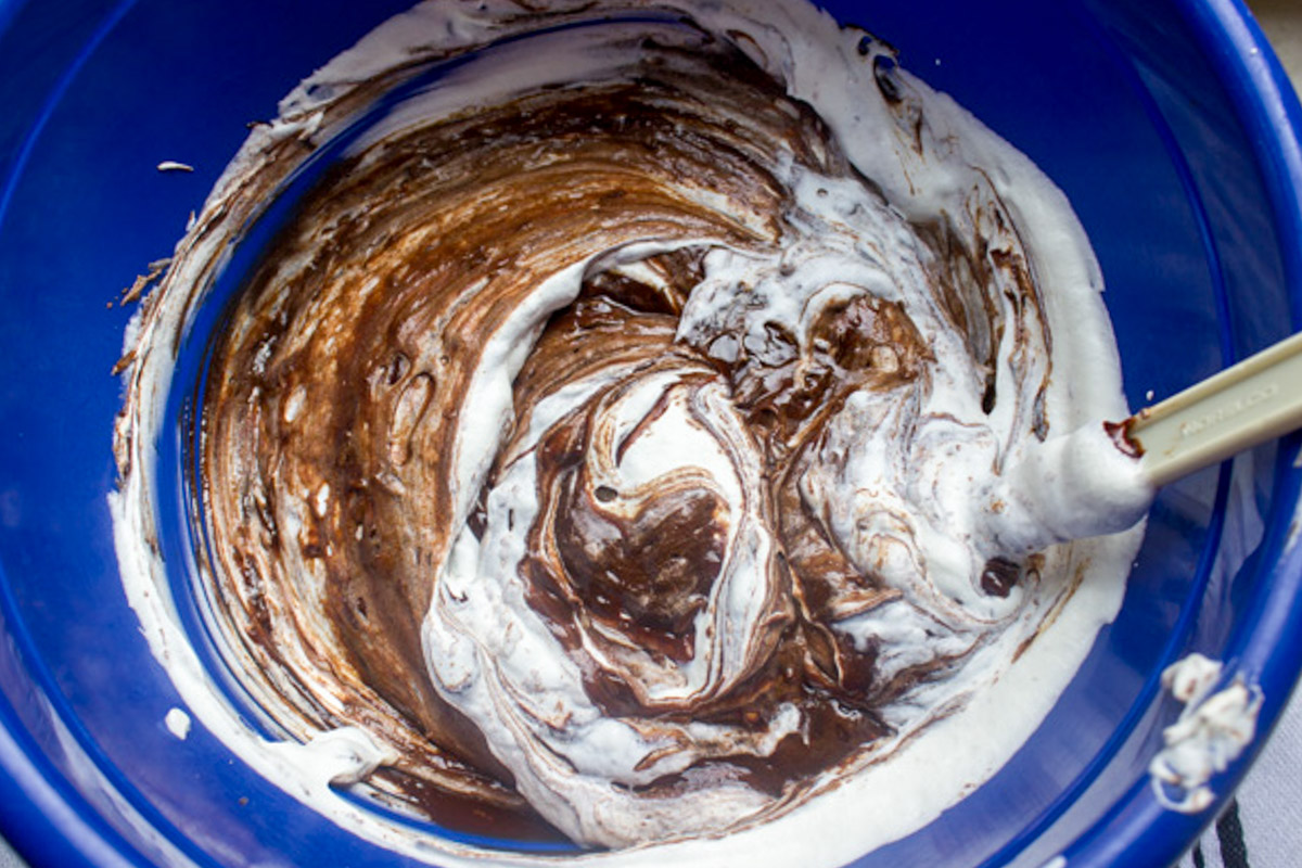 egg whites then whipped cream folded into chocolate mixture in bowl.