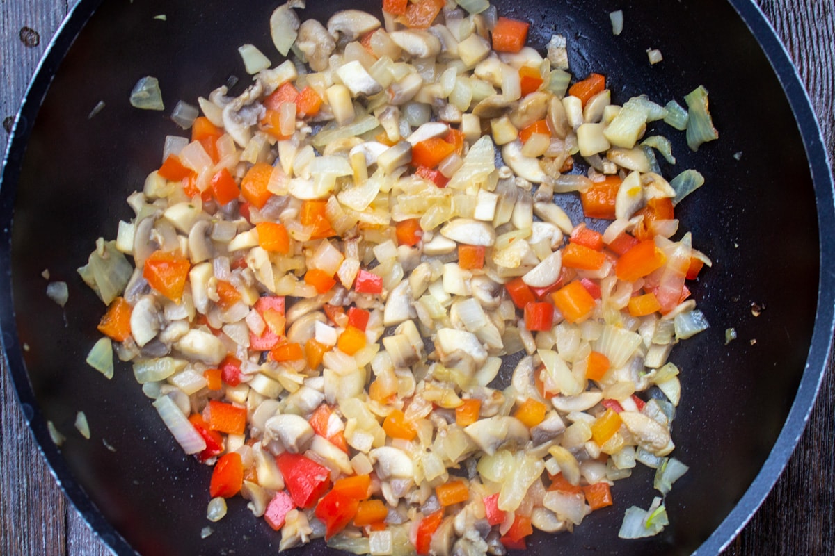 sauteed onions, mushrooms, peppers in skillet.
