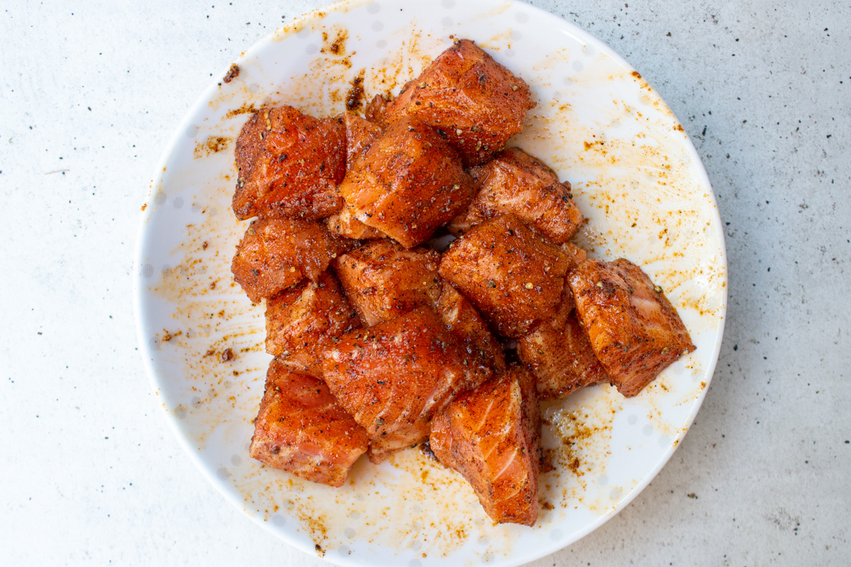 seasoned salmon cubes in a bowl.