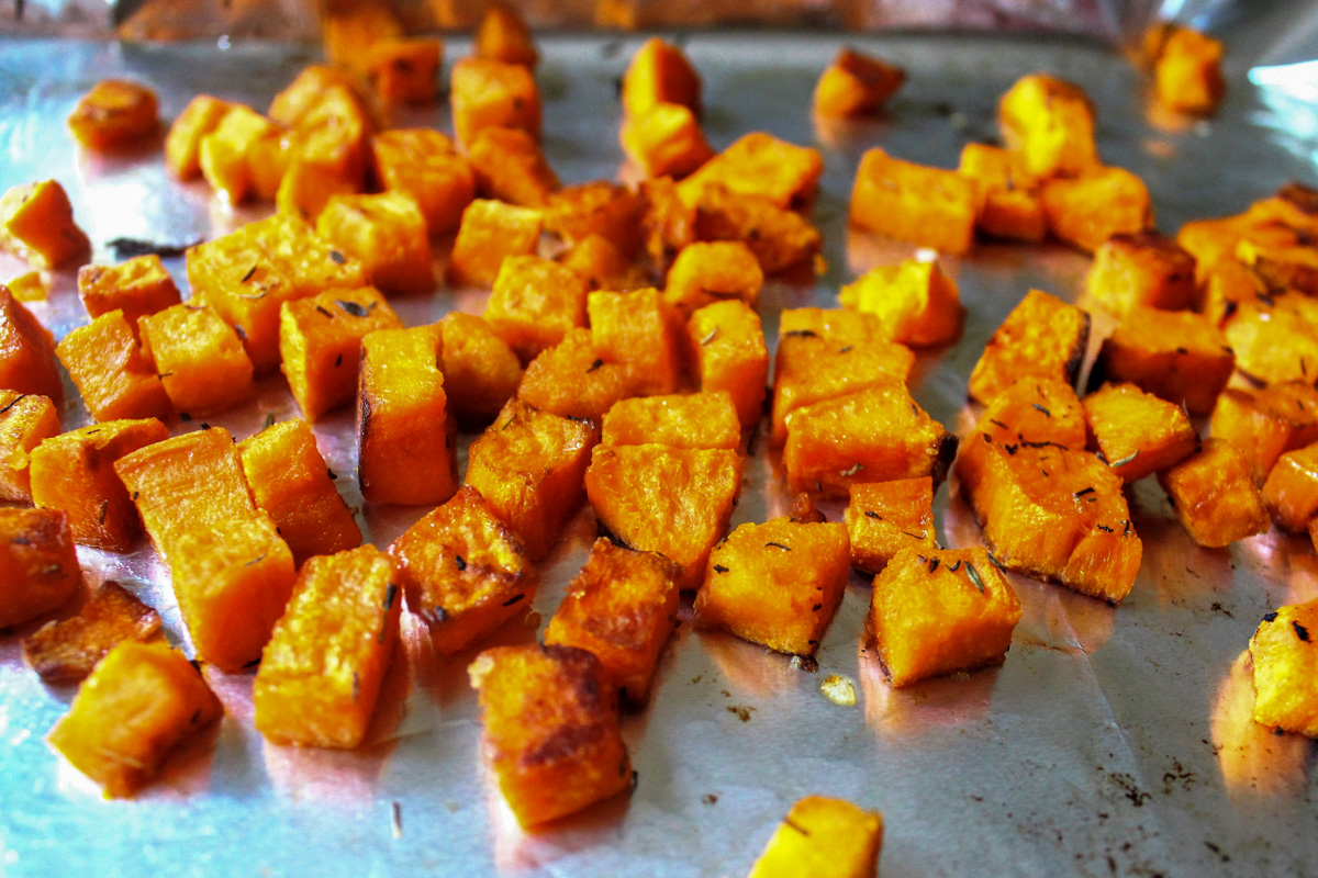 roasted sweet potato cubes on baking sheet.