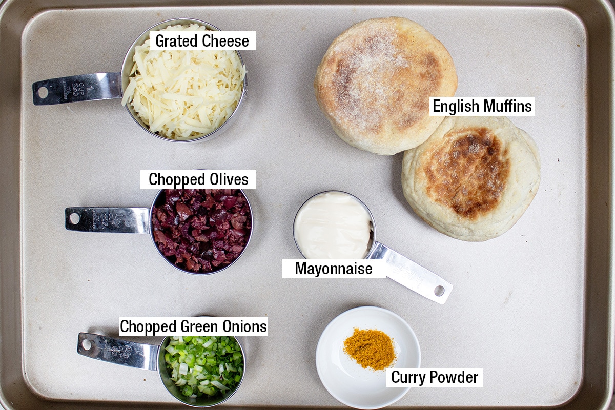 grated cheese, chopped olives, chopped green onions, curry powder, mayonnaise, 4 English muffins.