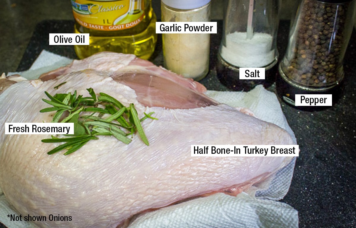 half bone-in turkey breast, olive oil, garlic powder, salt, black pepper, fresh rosemary, onions not shown.