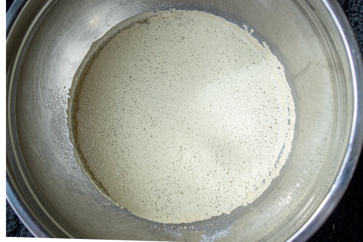 yeast mixed with water and sugar in bowl.