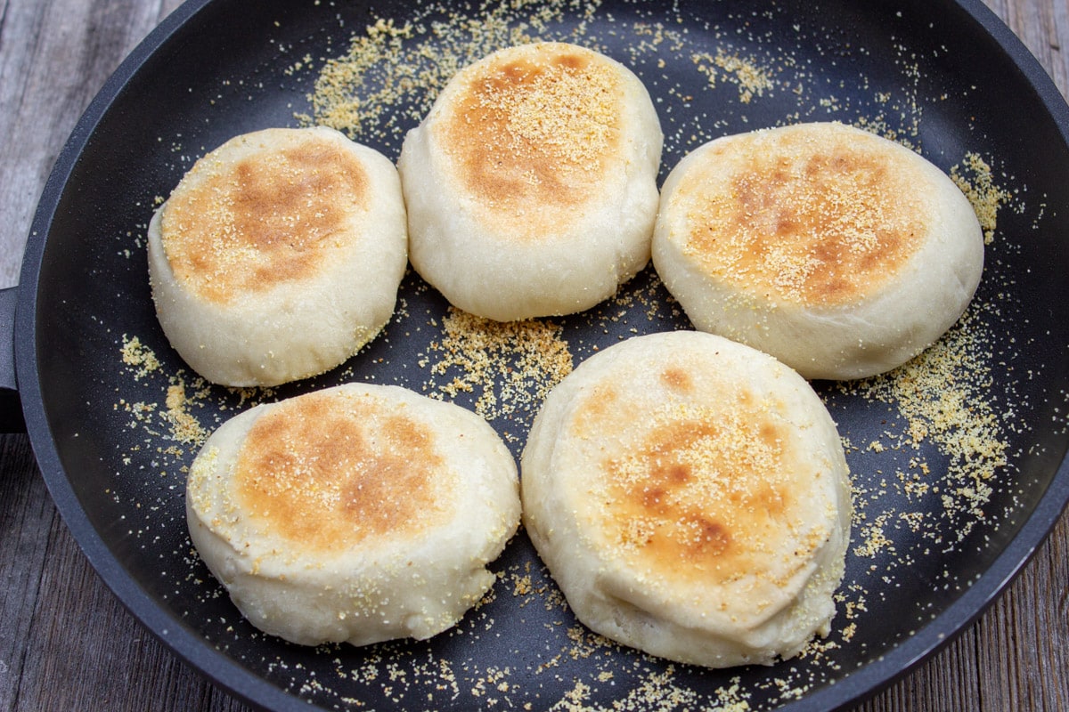 english muffins pan fried side up in skillet.