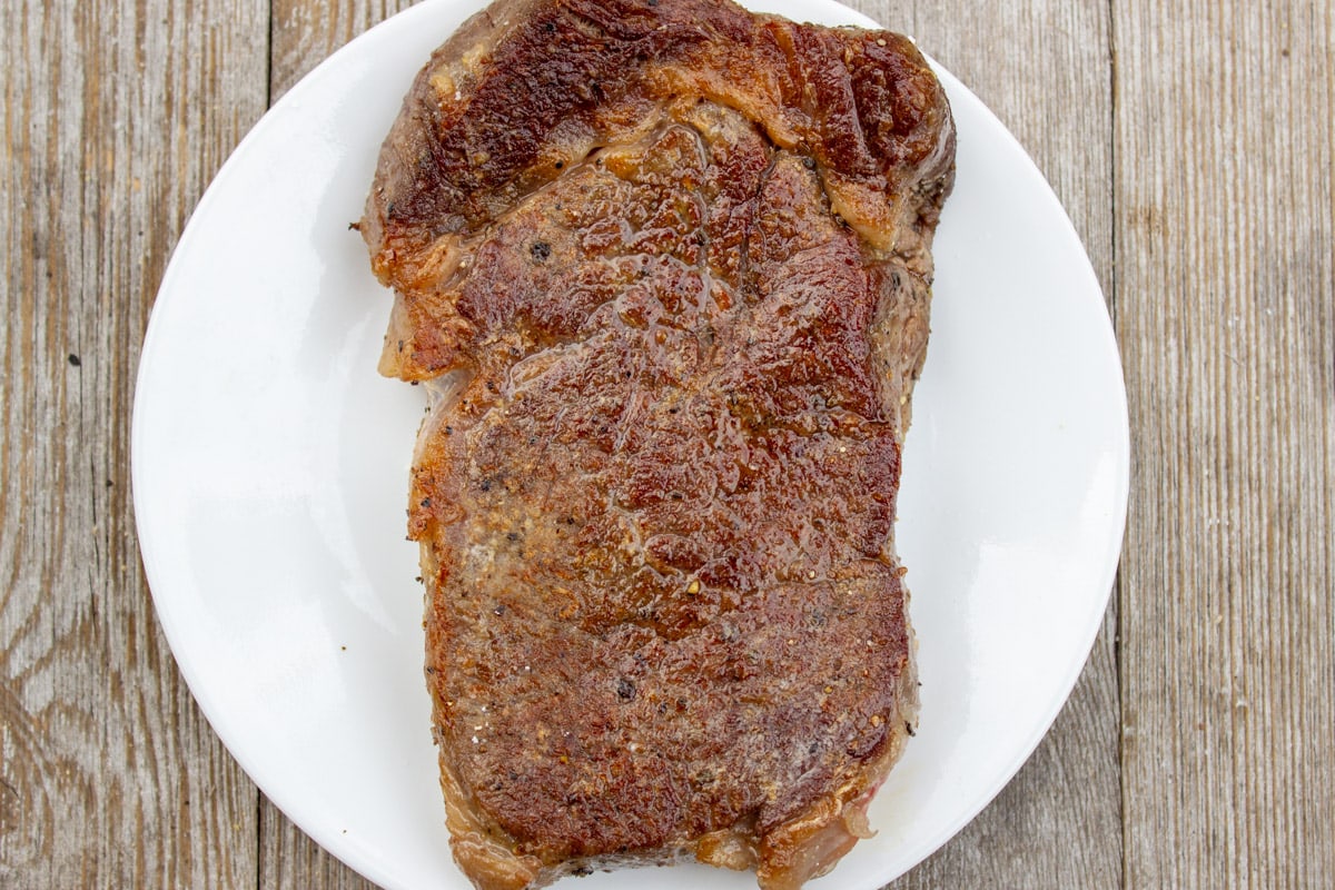 pan seared sous vide striploin steak on plate.
