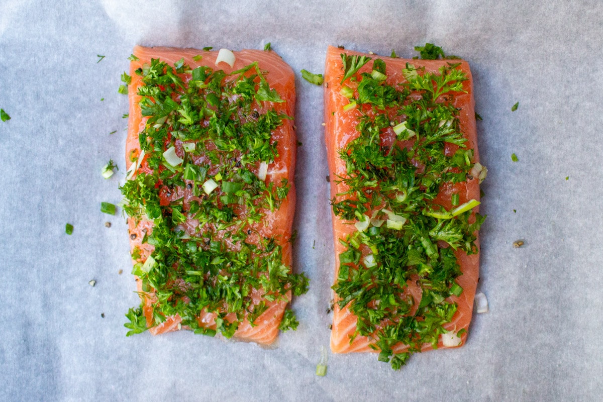 salmon fillets coated in fresh herbs, salt and pepper.