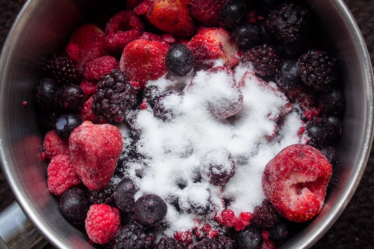 frozen berries, sugar and lemon juice in pot.