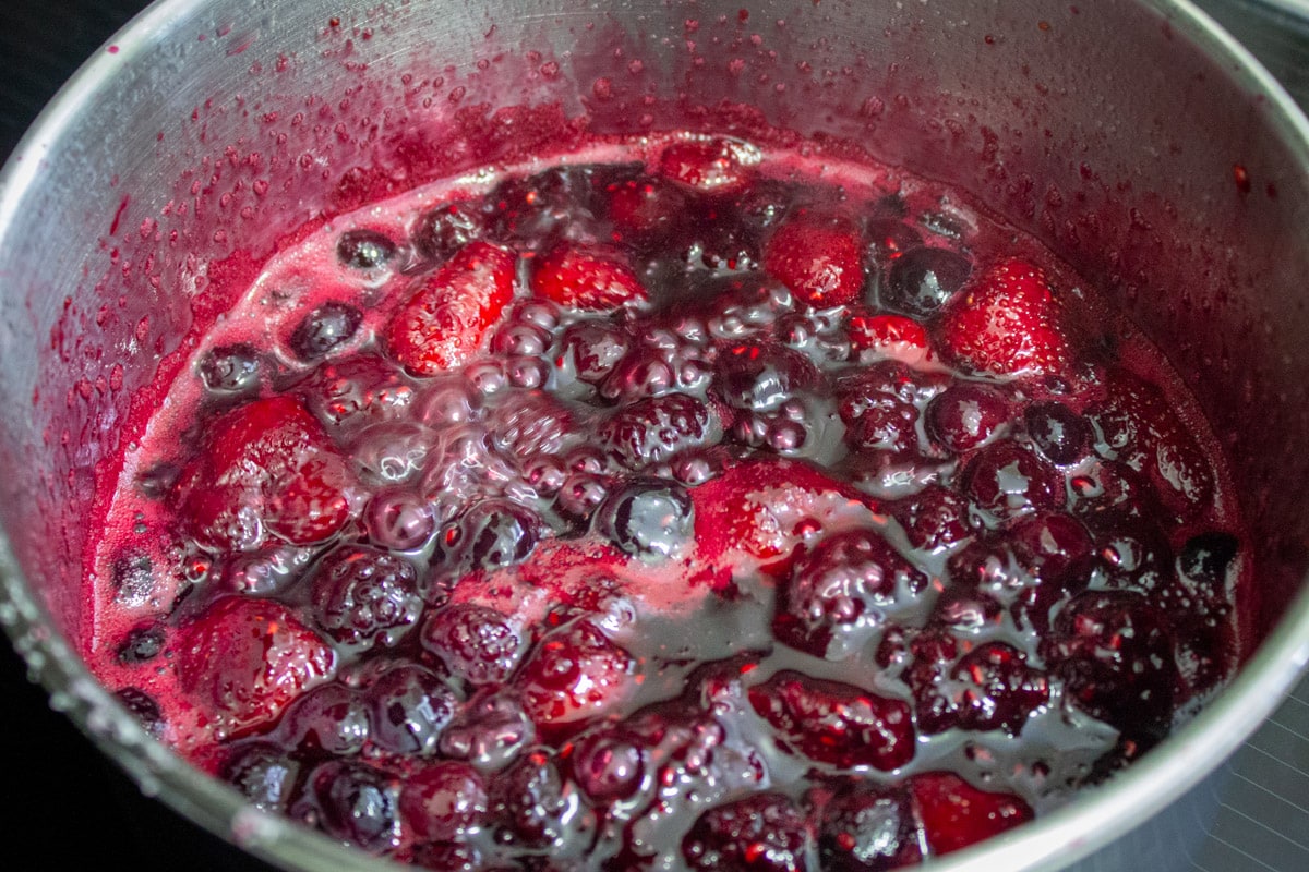 berry sauce mixture cooking in pot.