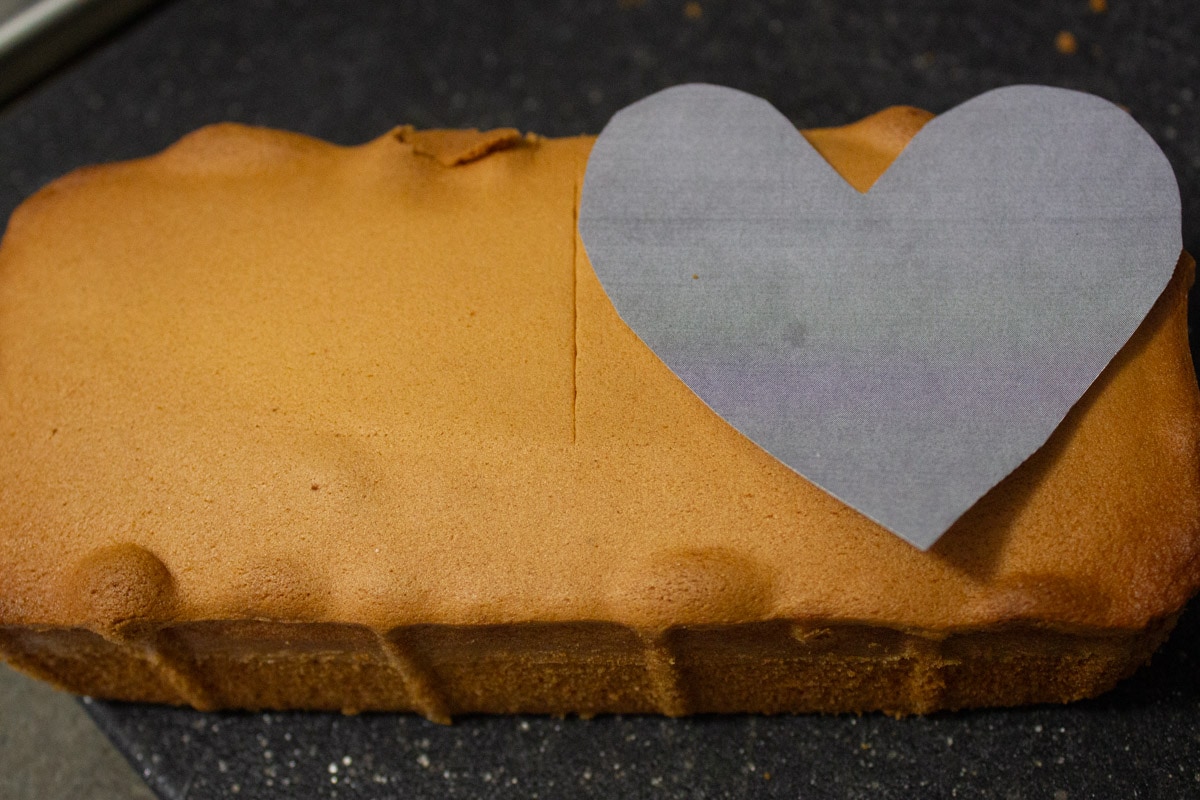 cut out paper heart on top of half the pound cake.