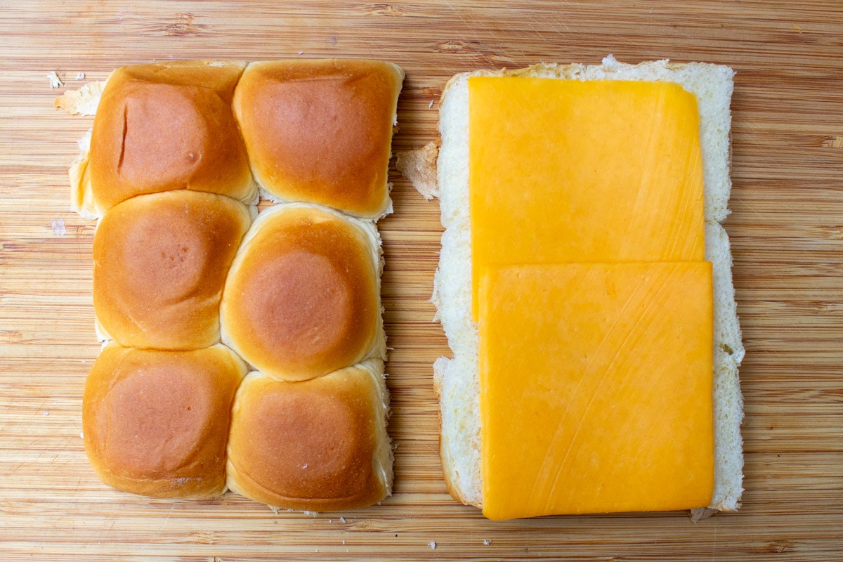 cheese on top of bottom layer of rolls.