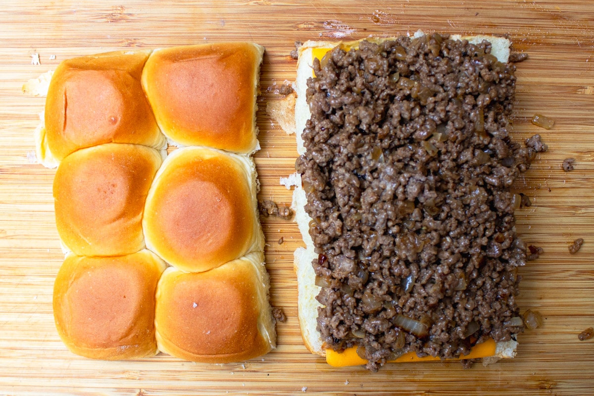 ground beef mixture on top of cheese layer on lower half of rolls.