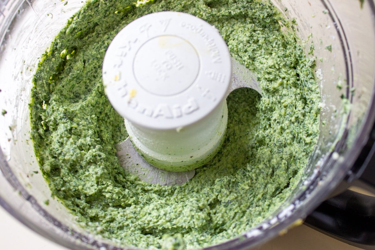 spinach cheese filling blended in food processor bowl.