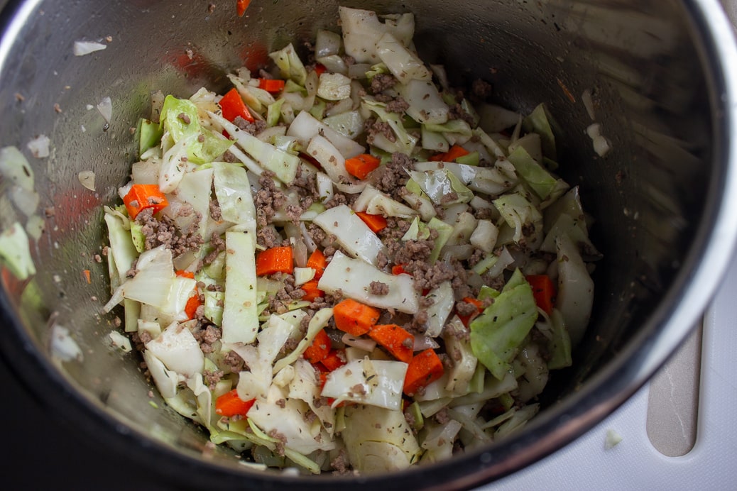 onions, carrots, cabbage and browned ground beef in instant pot.