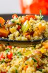 spoonful of vegetable stuffing with quinoa on skillet of stuffing.