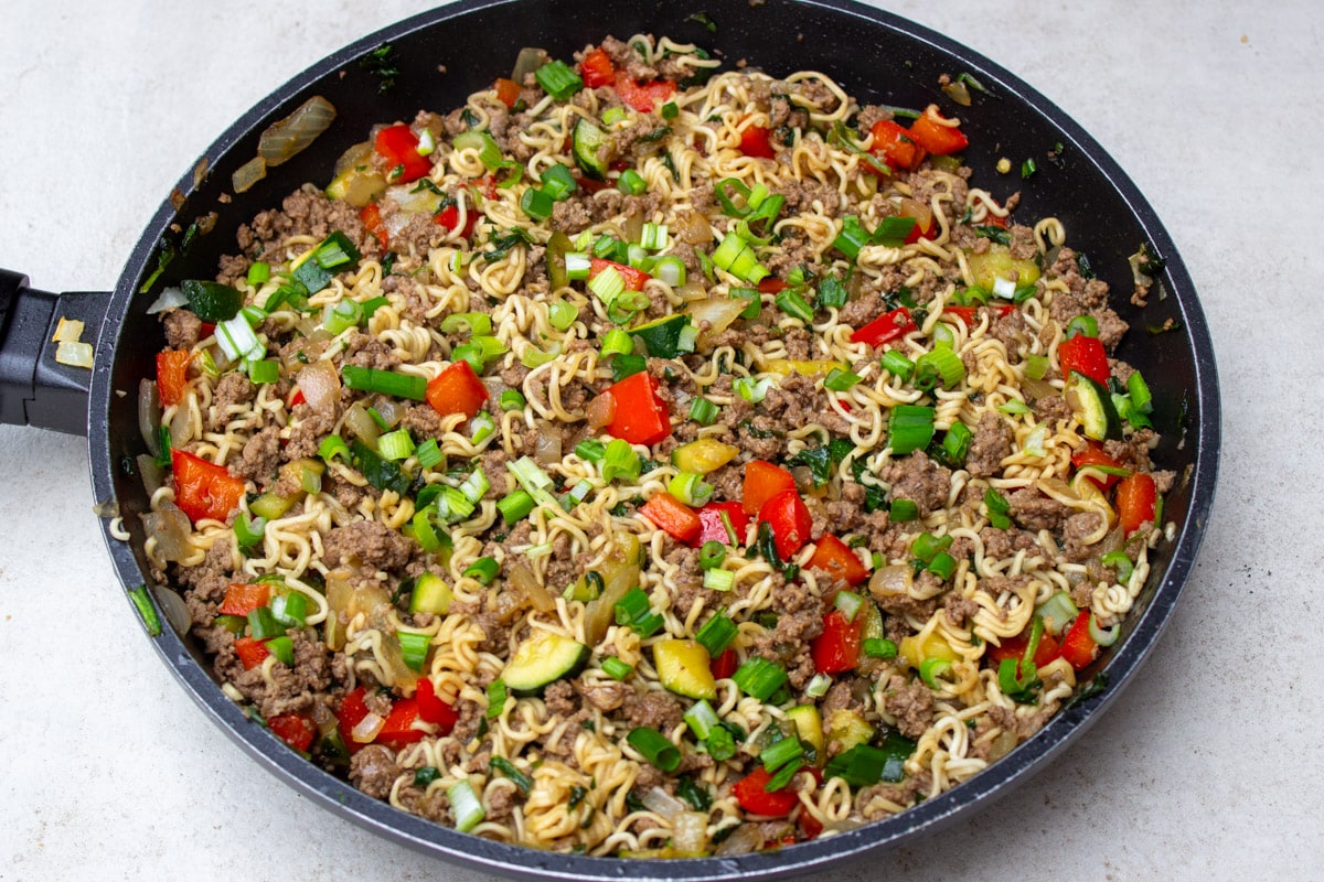 beef, noodles and mixed with vegetables in skillet.