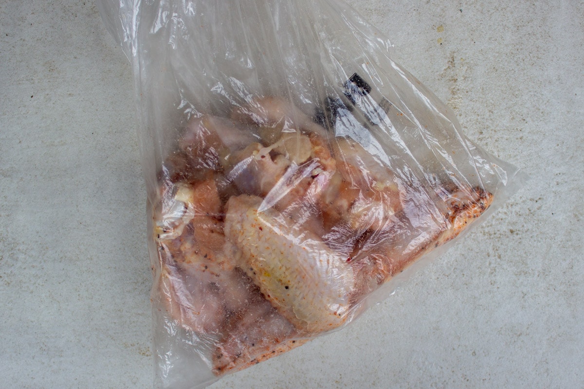 chicken wings in plastic bag with rub and baking powder.