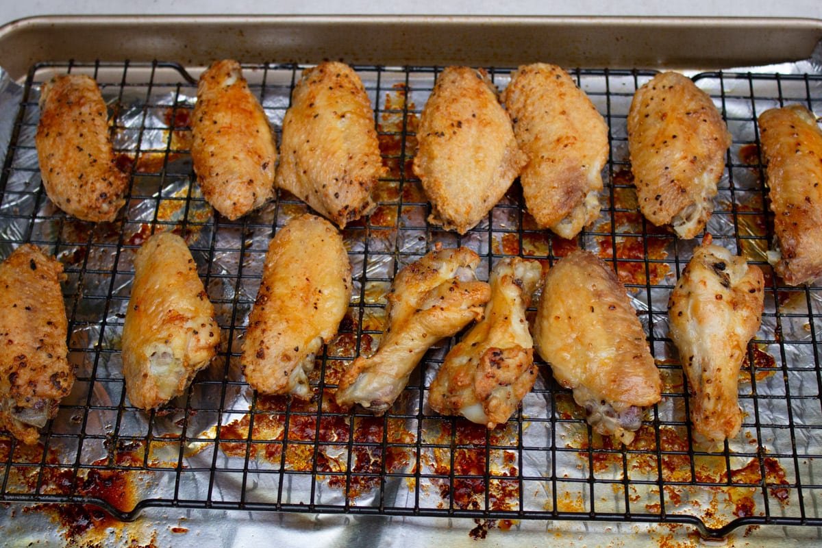 baked chicken wings on wire rack over pan.