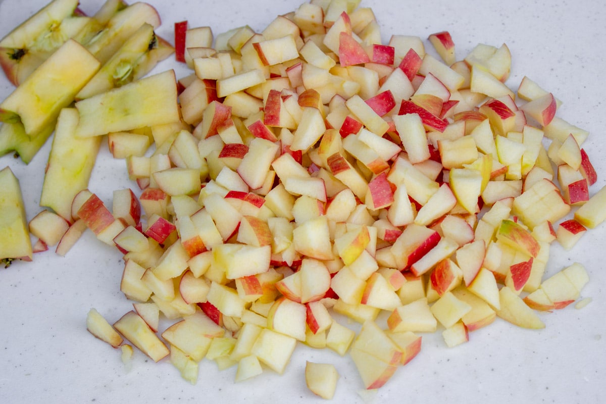 small diced apples with peel on cutting board.