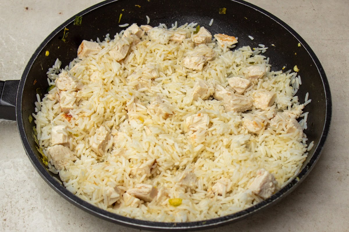 cooked rice and cooked chicken in pan.