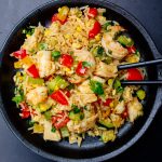 shrimp and chicken fried rice on plate with chop sticks.