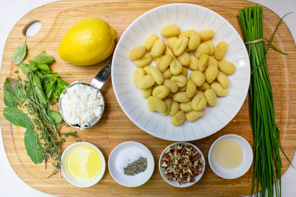 Store-bought gnocchi, ricotta, lemon, fresh herbs, chives, nuts, oil, salt, pepper, honey.