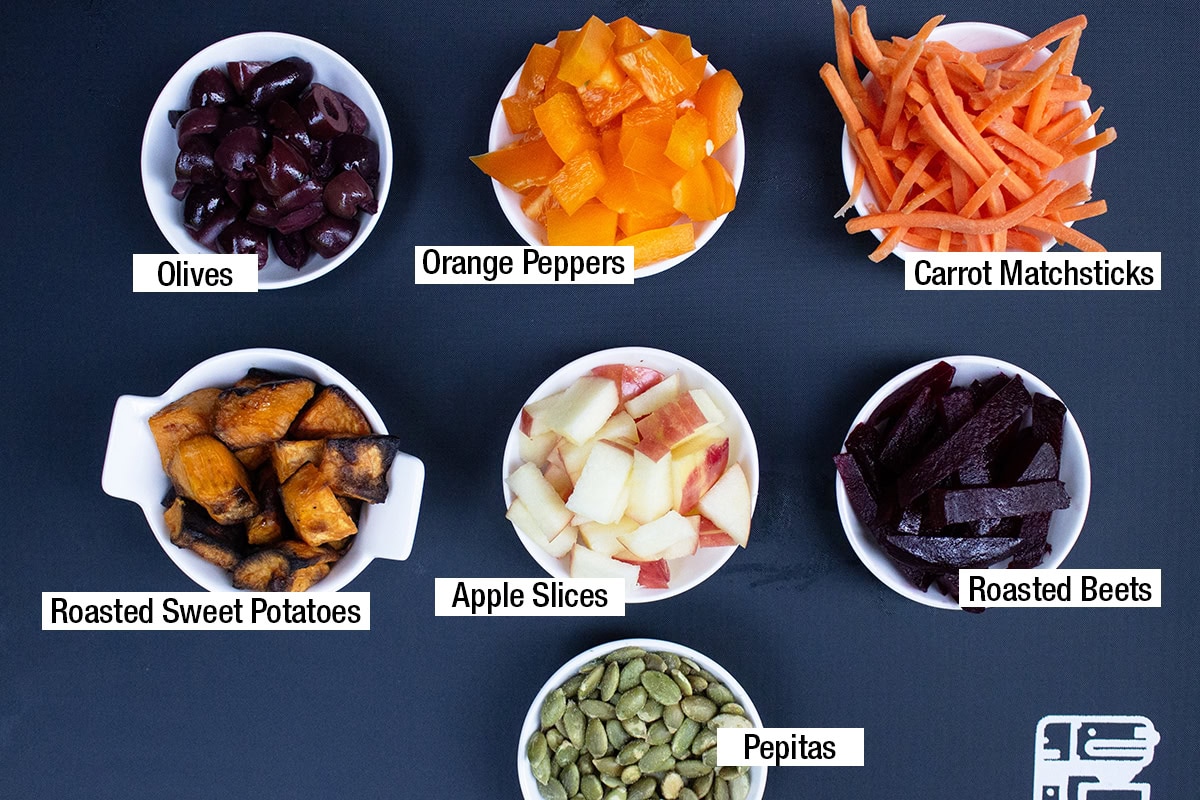 Olives, orange peppers, carrot matchsticks, roasted sweet potatoes, apple slices, roasted beets, pepitas.