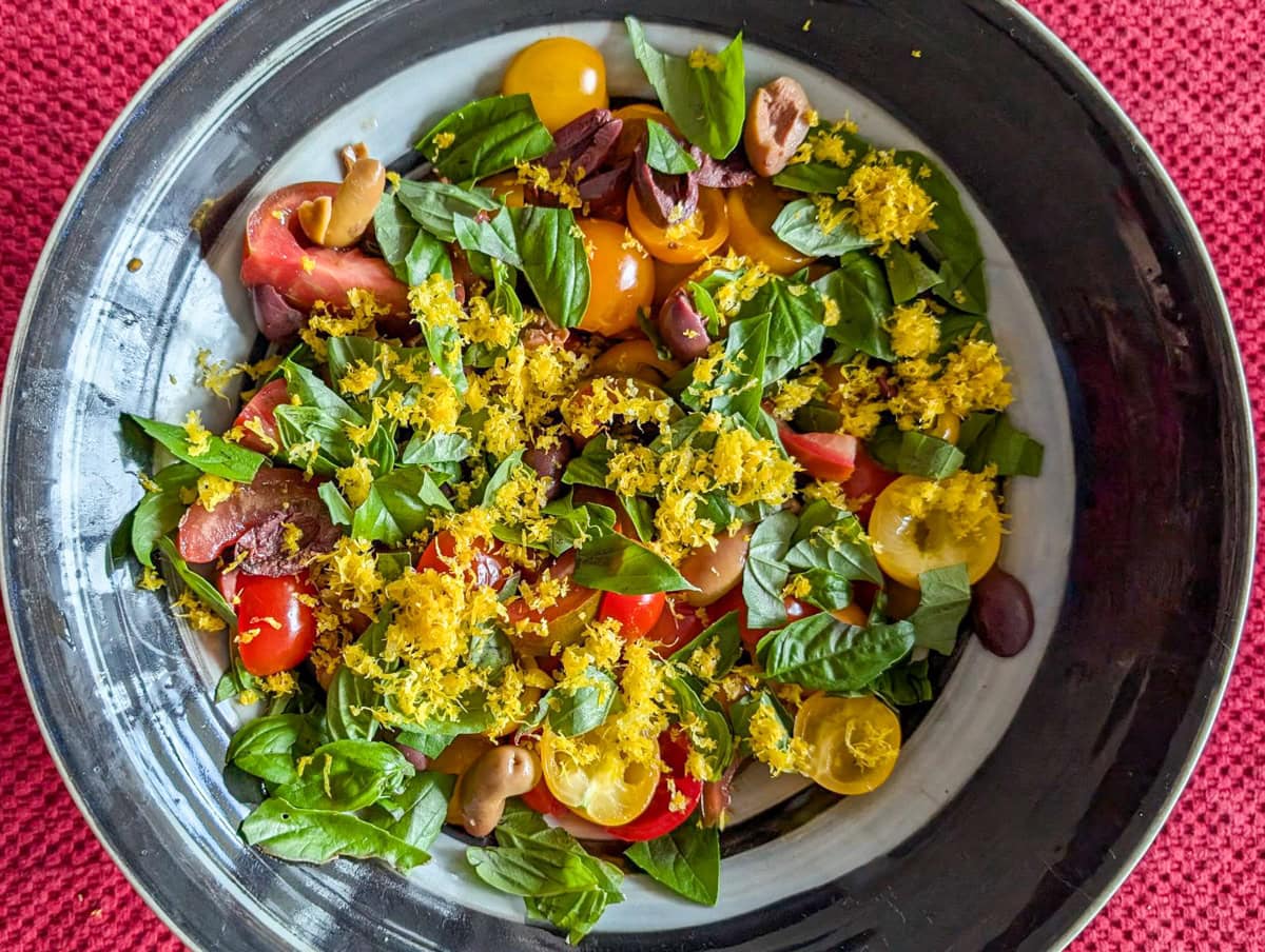 Tomatoes, basil and lemon zest in a bowl.