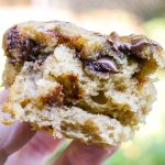 Cut open banana chocolate chunk muffin held up in hand.