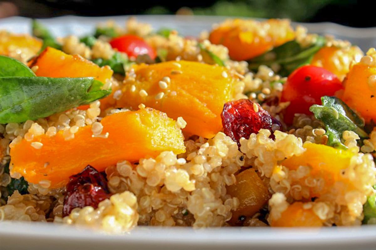 butternut squash salad with quinoa and spinach on serving platter.