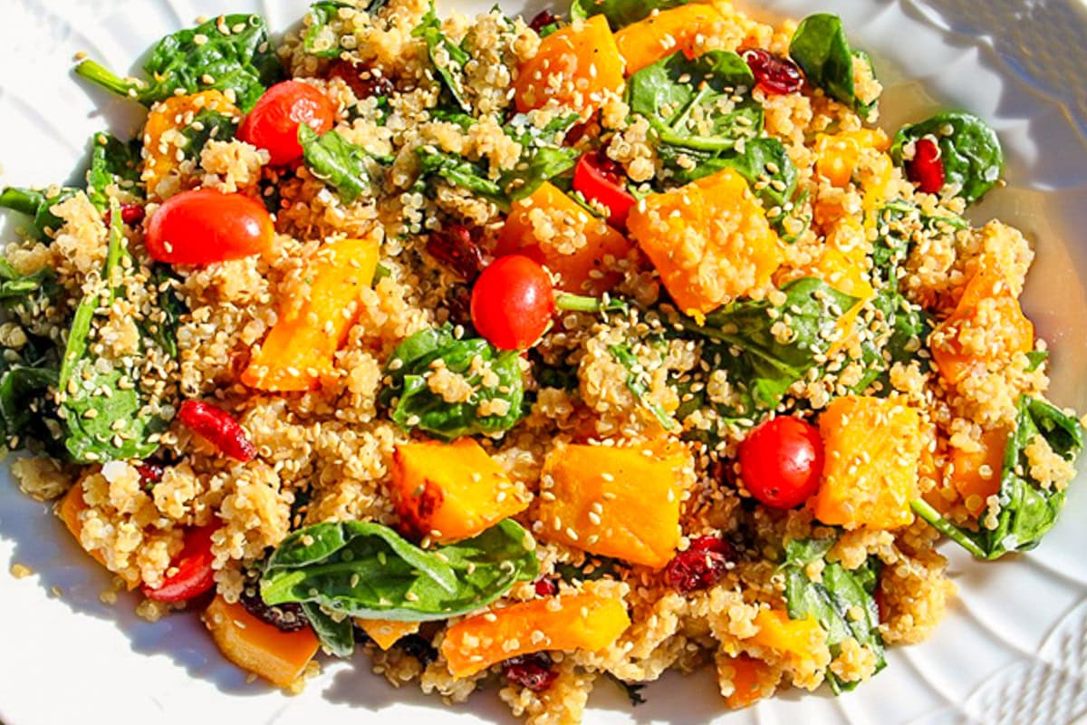 butternut squash salad with quinoa and spinach on serving platter.