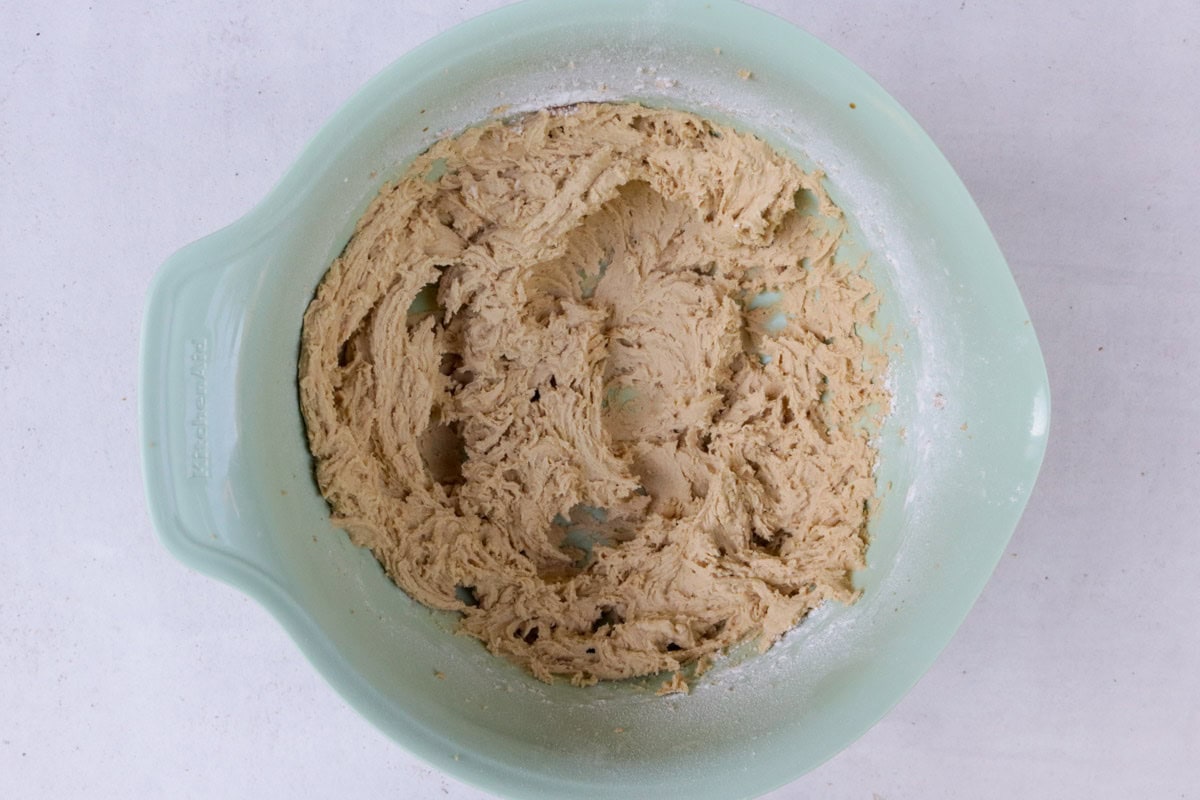 Butter, sugar, egg, vanilla and flour, beaten in bowl.