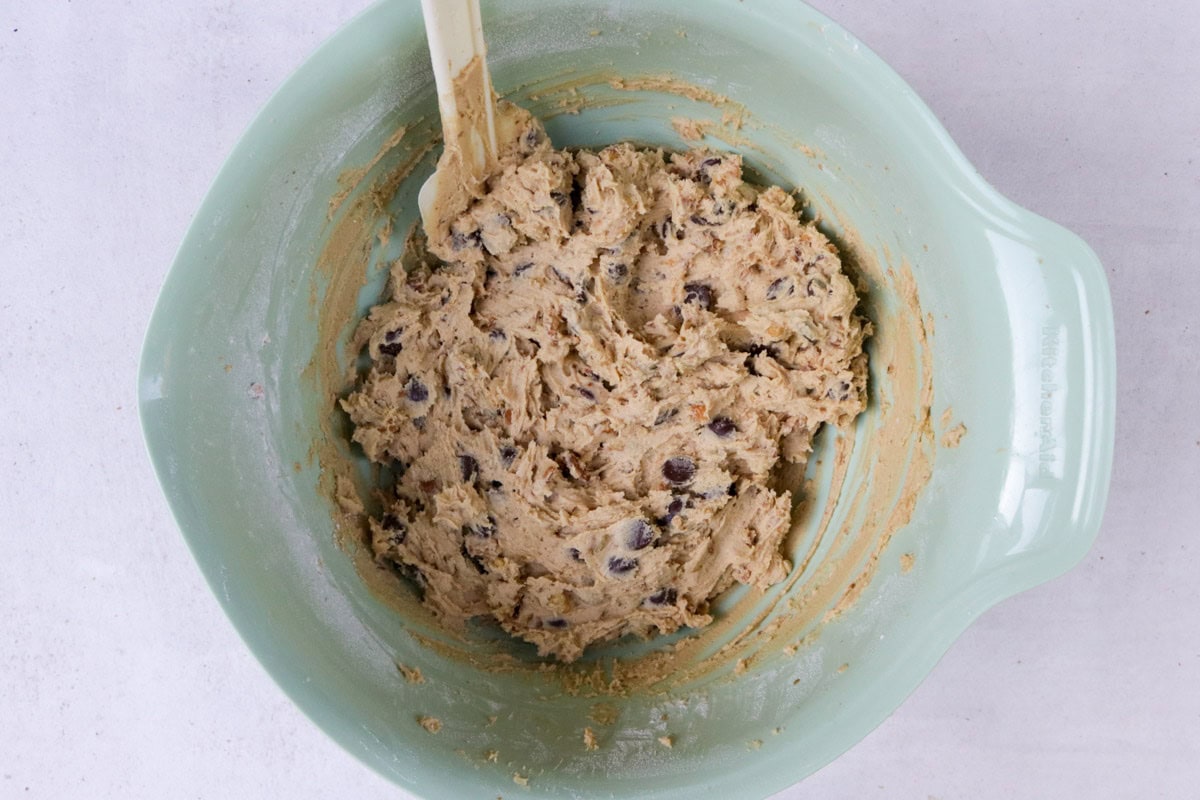 Nuts and chocolate chips in batter in large bowl.